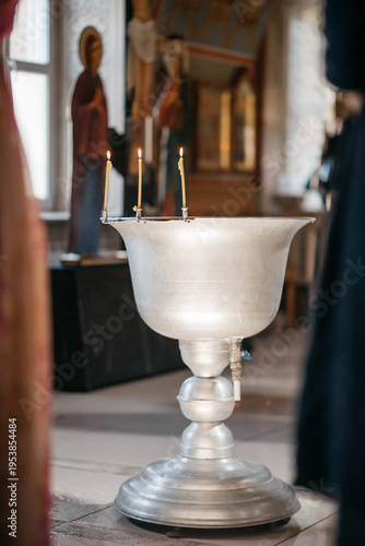 Billede på lærred baptismal font with three candles in the church