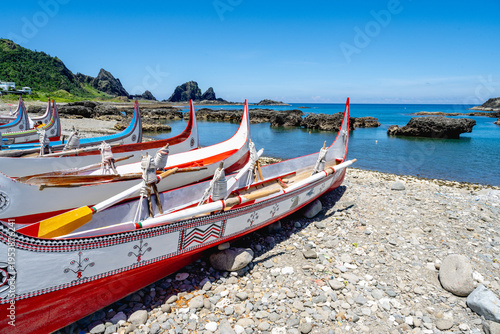 Konstfotografi Lanyu, Taiwan - June 24, 2025: Traditional Tao plank boats on the shore with volcanic bay view