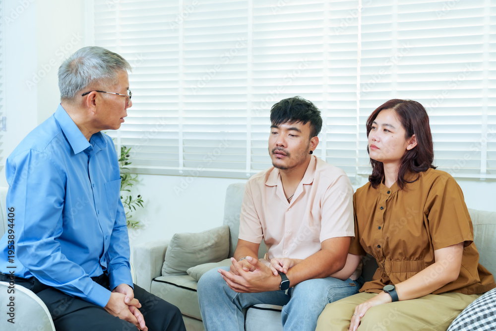 Obraz premium Senior asian psychiatrist talking seriously with adult couple sitting together during marriage counseling session helping them find emotional balance understanding representing trust guidance mental