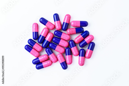 Close-up of omeprazole gastro-resistant capsules (proton pump inhibitor) on white background for gastrointestinal treatment