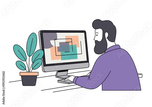 Male graphic designer working on desktop computer at workplace