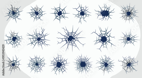 Collection of dark blue spiderweb-like cracks on glass from a central impact point isolated on a light grey background.