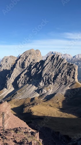 Massive Rocky Peaks of the Dolomites Viewed from Mountain Pass – 4K Vertical