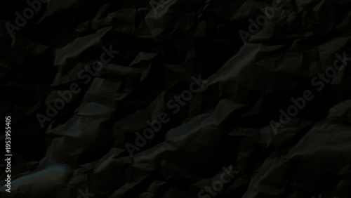 Closeup of a dark crumpled paper texture with creases and folds detailed view