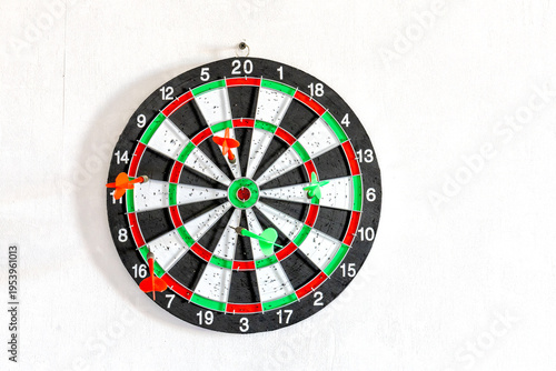 Fotografija Dartboard with darts on wall target in daylight