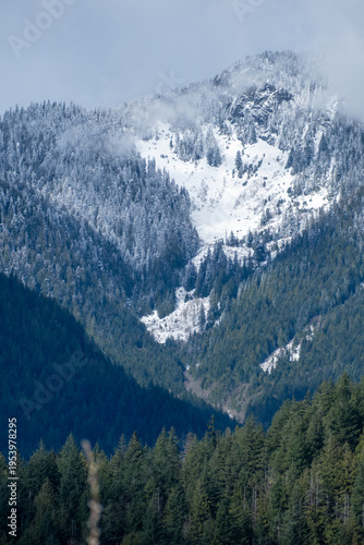 Recent snow dusts mountain peak near Pitt Lake, BC, Canada