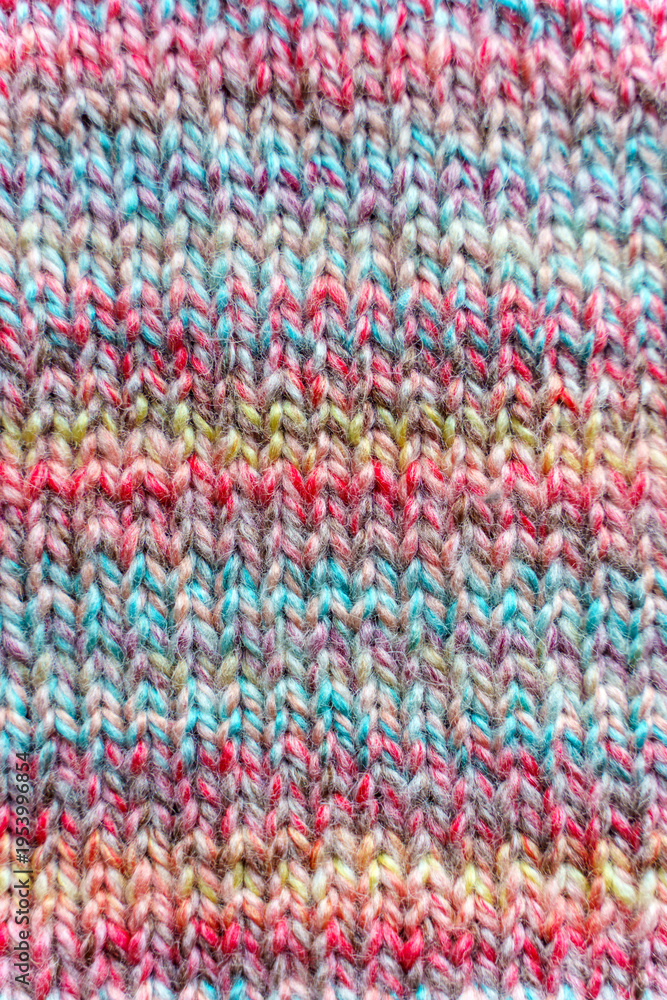 Fototapeta premium Close-up Texture of Handmade Knitted Clothing with Colorful Yarn Patterns