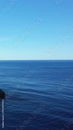 Tranquil blue sea and clear sky meet at the horizon near Capo Palinuro, Italy. Minimalist seascape with serene natural beauty.