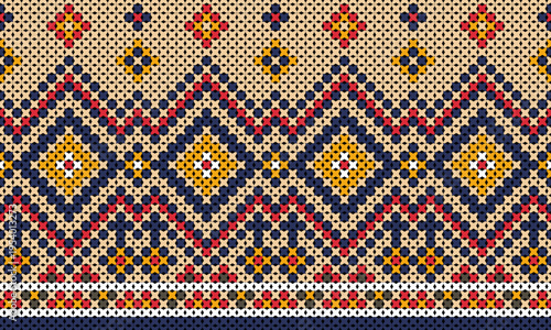 Contemporary Native Indian-style cross-stitch pattern in dark blue, red, and yellow.