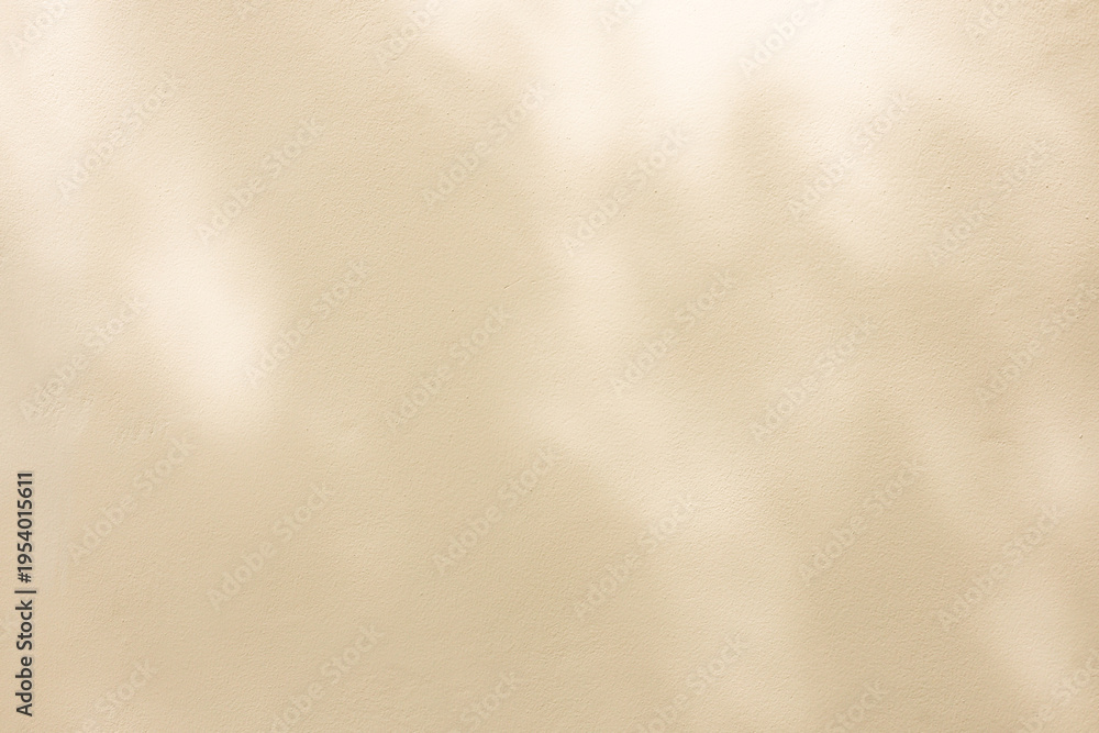 Fototapeta premium close up on beige plain wall background texture with shadow of window from sunlight for ads and advertisement product such as cosmetic or content or goods design display concept
