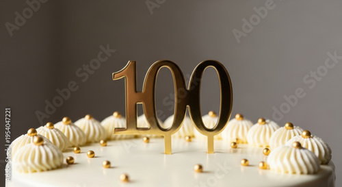 White Cake Adorned with Golden 100 Candles, Celebrating a Centennial Milestone with Creamy Swirls and Golden Accents Illustrating a Creative Art and Design Concept