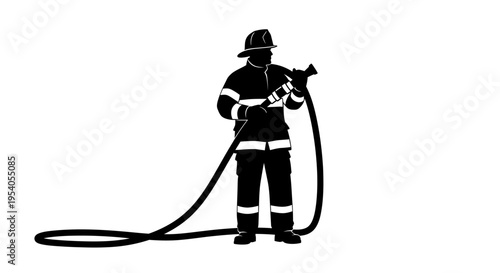 Firefighter in uniform holding a hose nozzle standing ready for action