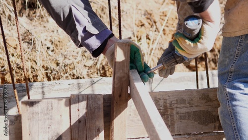 Photography Hands Assembling Wooden Construction Formwork For Foundation, Workers Aligning T