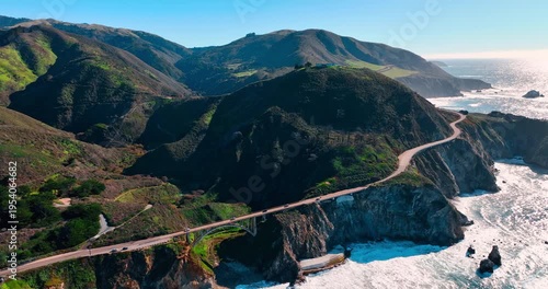 Aerial view of Bixby Creek Bridge on Highway 1 California. Drone shot of concrete arch bridge and coastal mountains along Big Sur Pacific coast