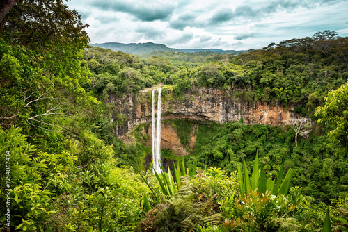 Aerial drone view of Chamarel Waterfall cascading through lush tropical forest in Mauritius, one of the island’s most famous natural landmarks
