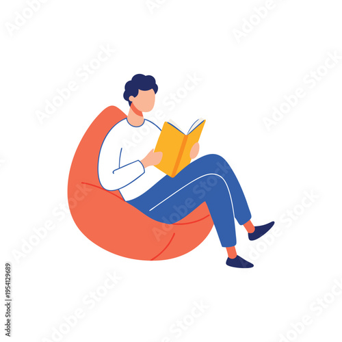 Young man comfortably sitting on a large beanbag chair reading an open book