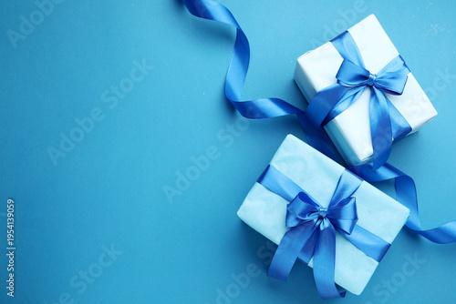 Beautiful Christmas gifts on light blue background, flat lay. Space for text