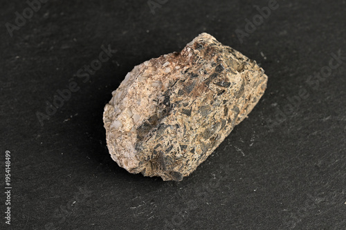 Valokuva Close-up of a rough, textured igneous rock specimen with visible mineral inclusi