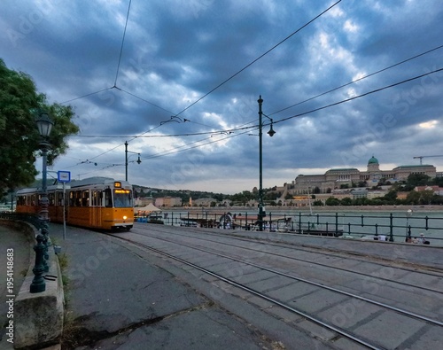 Iconic Yellow Tram by the Danube River with Buda Castle, Budapest
