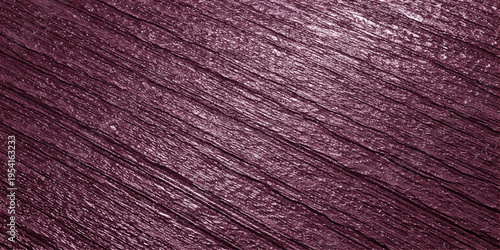 A detailed close up view of a dark purple textured surface with diagonal lines and metallic sheen
