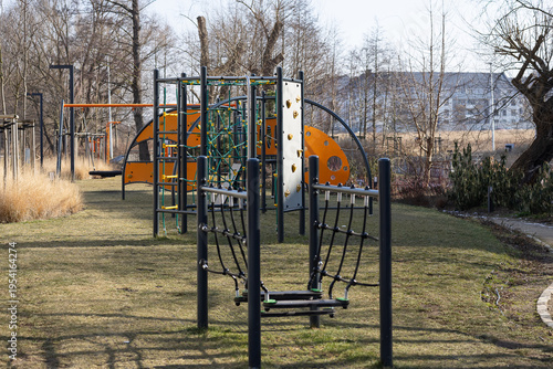 Modern urban landscape design featuring an aesthetic and multi-functional outdoor playground for residents with climbing frames and rope nets in a sustainable residential area