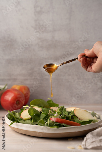 Honey drizzle over apple salad healthy food concept