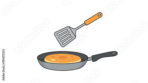 Round golden pancake being flipped with a metal spatula over a dark gray frying pan on a white background representing home cooking and breakfast.