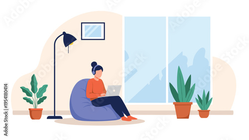 Young woman works on her laptop while sitting comfortably in a blue bean bag chair in a bright living room with large windows and plants.