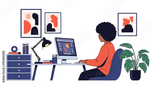 Back view of an African American woman working at an organized computer desk in a creative home office workspace.