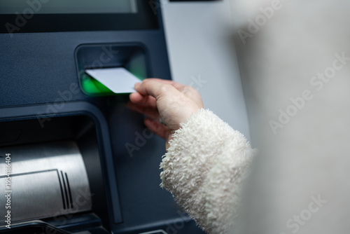 Obraz na plátně Person inserting atm card into cash machine slot