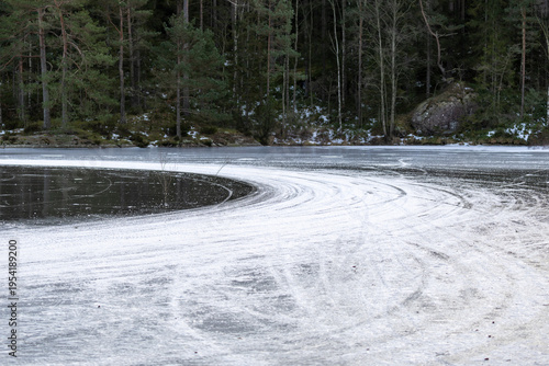 Ice racing car tracks on frozen lake