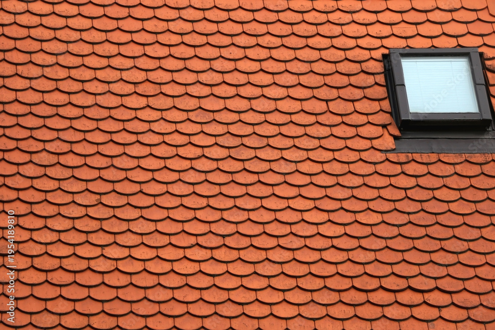 Fototapeta premium Slate roof with traditional red tiles and windows. 