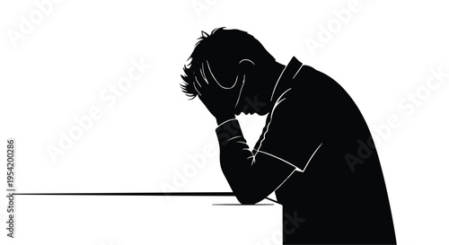 Sad man sitting alone frustrated with head in hands at desk in dark silhouette isolated on white background