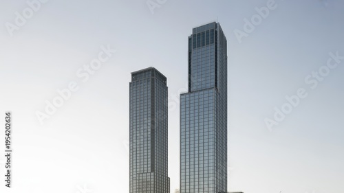 Two modern skyscrapers standing tall against a clear sky