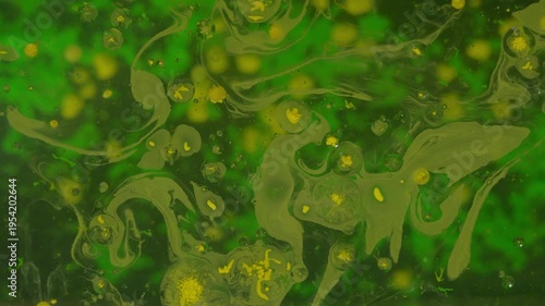 Yellow paint bubbles with green backdrop