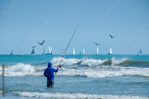 Experience Coastal Serenity: Fishing by the Ocean with Sailboats and Seagulls in New Smyrna Beach Florida, USA