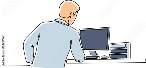 A man sits at a desk working on a computer