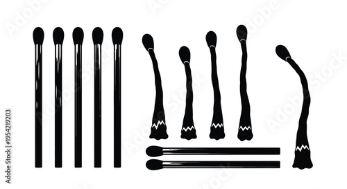 Collection of black makeup brushes displayed in a striking silhouette