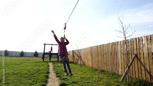 Little beautiful girl is riding zipline