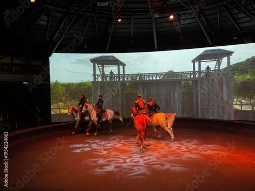 A captivating live horse performance featuring skilled riders in a circular arena stage with dramatic lighting and a cinematic medieval backdrop. 