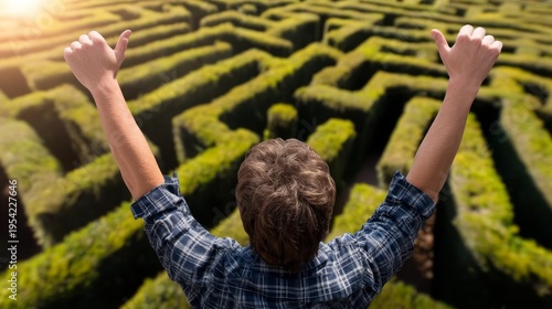 Person Inside Tall Hedge Maze Celebrating Achievement with Thumbs Up