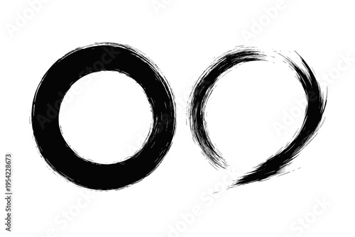 Two abstract black ink circles painted with a brush on a white background