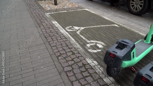 Electric scooter parking zone on a city sidewalk for micro mobility.