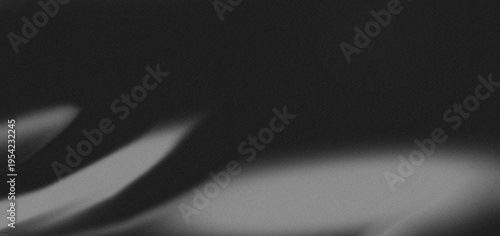 Dramatic low-key shadow of hand reaching on dark textured surface