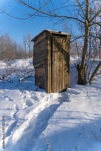 Wallpaper Mural Weathered old wooden outhouse stands on snow covered rural ground Torontodigital.ca