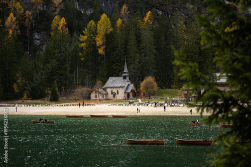 Chapel by Lake in Autumn Dolomites Italy