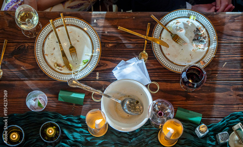 High angle view of elegant dinner table for a reception after everything has been eaten, with dirty dishes.