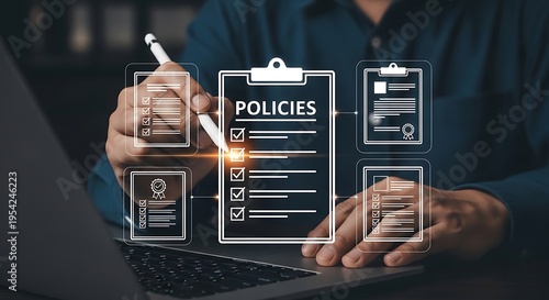 Man in blue shirt using laptop with policies and documents on screen