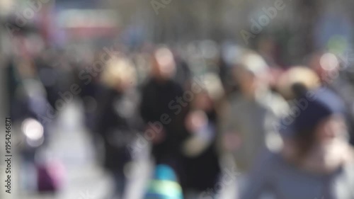 Blurred Crowd of Pedestrians on Sunny Winter Street