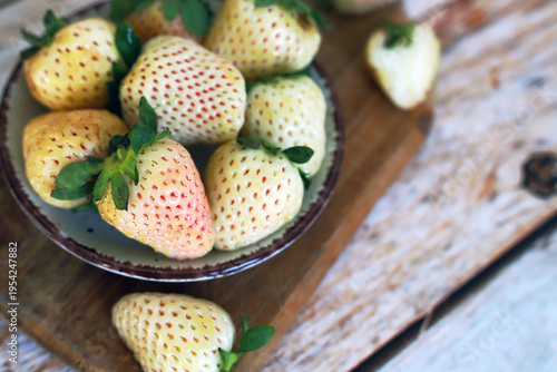 White strawberry pineapple on a wooden board.
